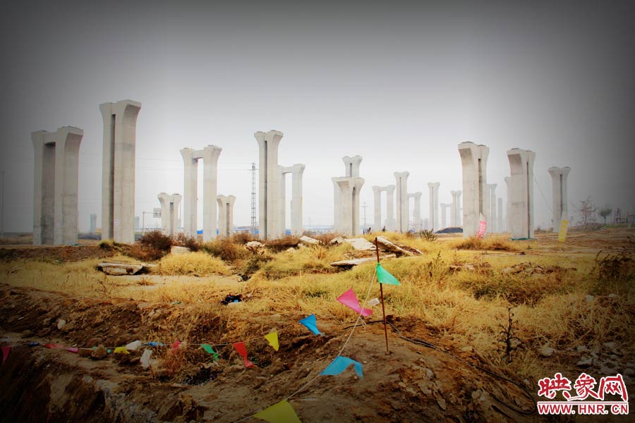 由于項目已經(jīng)停工數(shù)月，施工工地上很難見到工人，設(shè)備也很少，雜草叢生，顯得非?；臎觥? width=