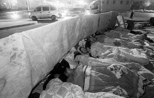 在寒冷的冬夜，為了能省點(diǎn)錢，方便接活，民工們?nèi)运跇蛳隆? complete=
