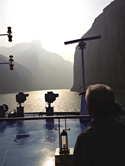 　　游客在游輪上遠(yuǎn)眺三峽風(fēng)光。