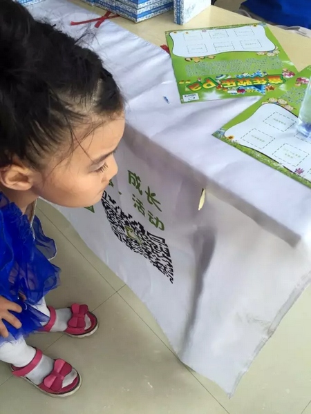 一只蝴蝶飛到小蝸牛的旗子上，小朋友看得入神啦~