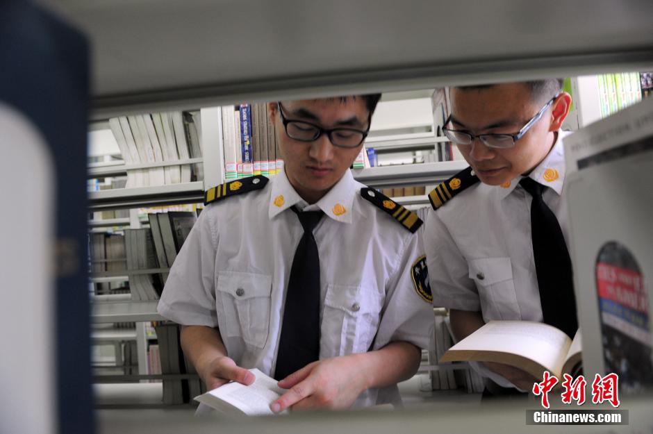 5月8日，武漢輕工大學圖書館保安吳濤與江力在圖書館交流學習。