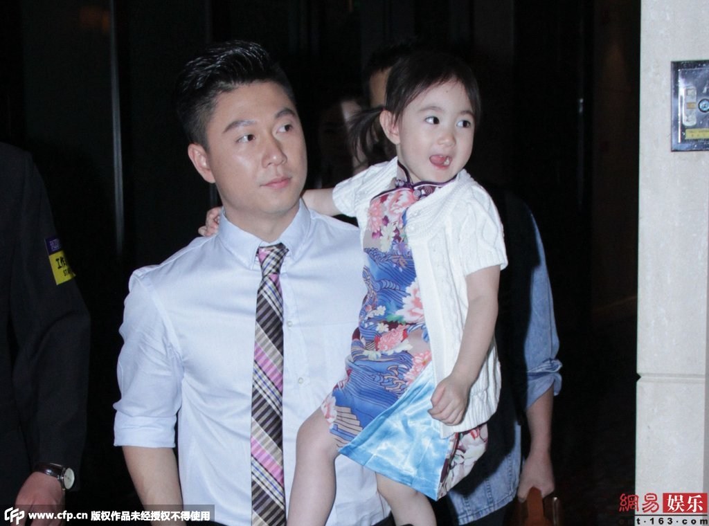 女兒奧莉身穿花旗袍配白色外套，還不停做表情賣萌搶鏡。